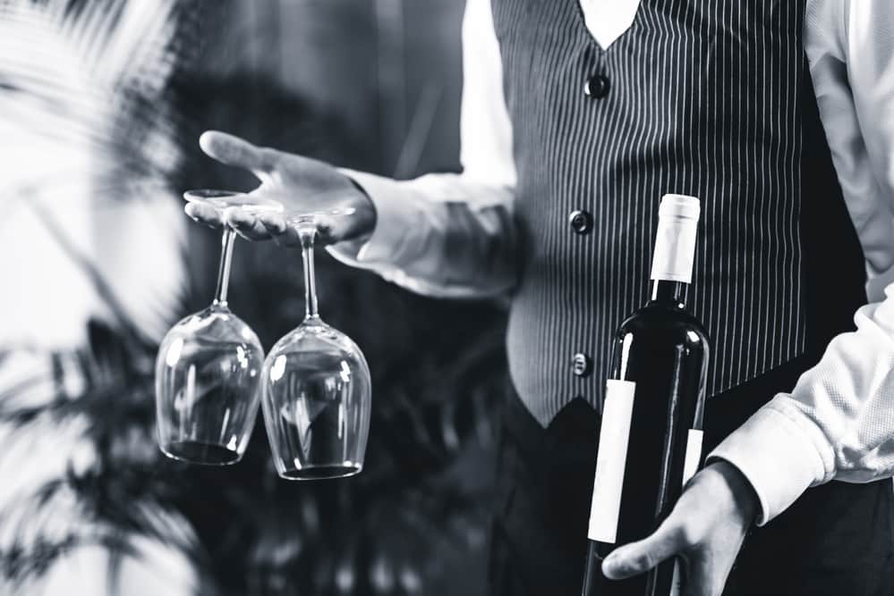 sommelier-holding-wine-bottle-and-wine-glasses