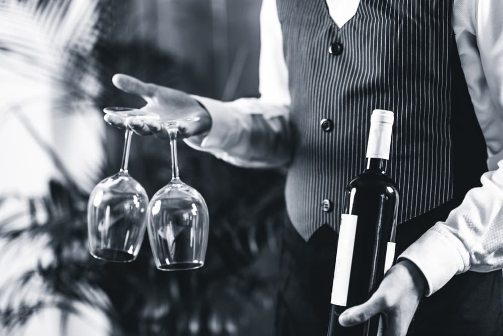 sommelier-holding-wine-bottle-and-wine-glasses