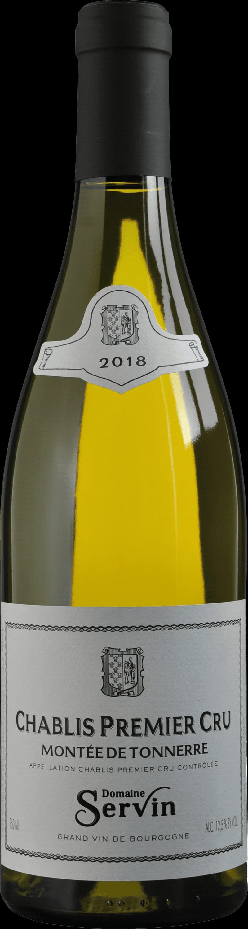 Ett glas Chablis vitt vin på ett bord med grön bakgrund.