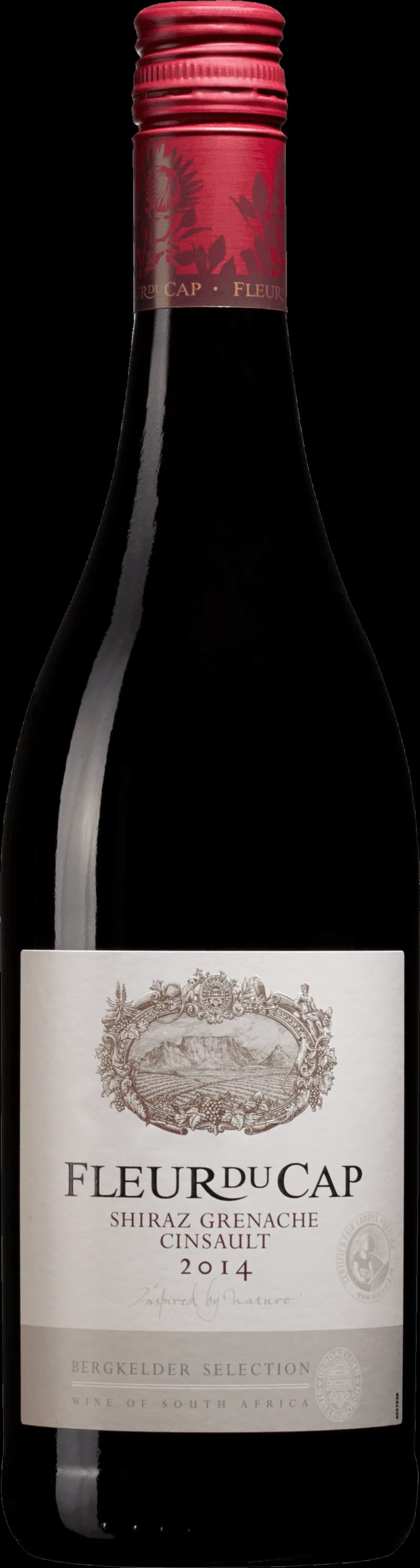 Fleur du Cap rött vin i ett vinglas mot en mörk bakgrund