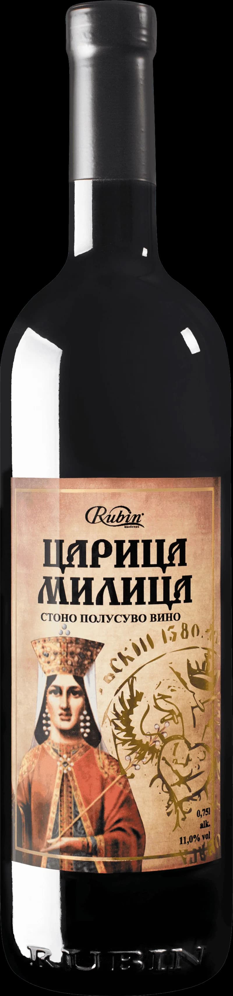 Ett glas fyllt med rubinrött vin mot en mörk bakgrund.