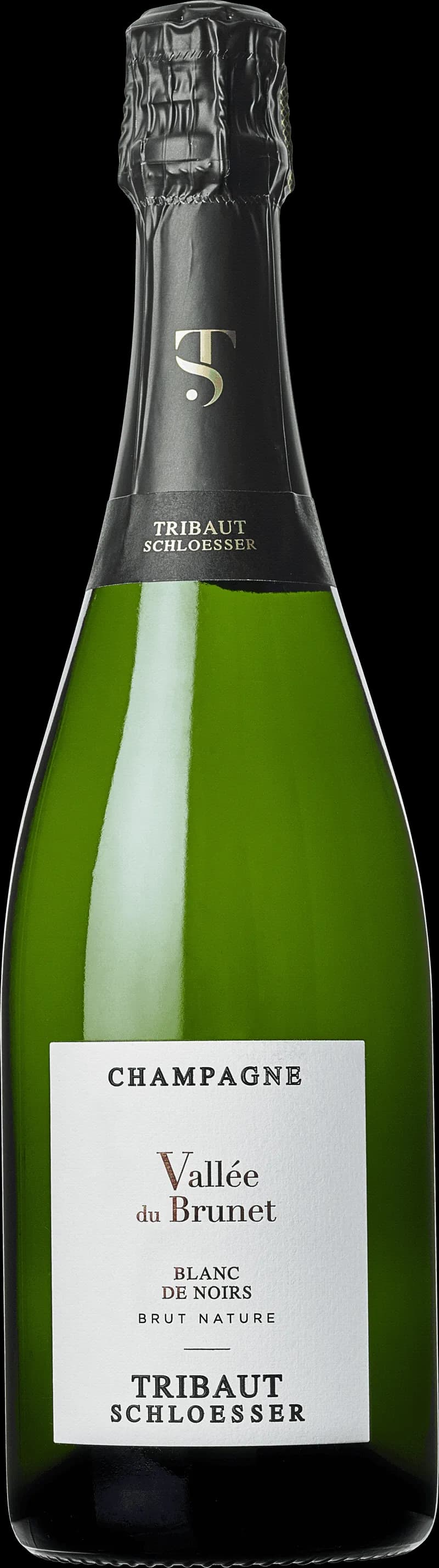 Flaska med Tribaut mousserande vin mot ljus bakgrund.