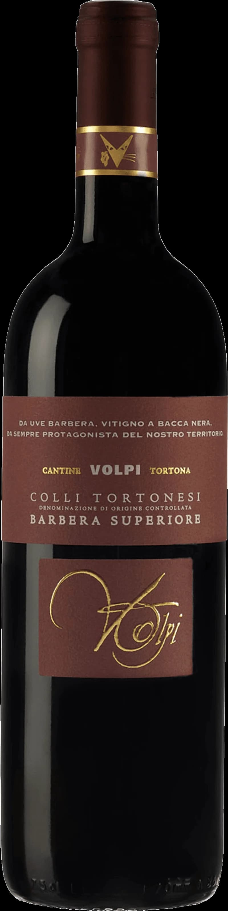 Flaska med Volpi rött vin på en bordduk, omgiven av vinglas och druvor.