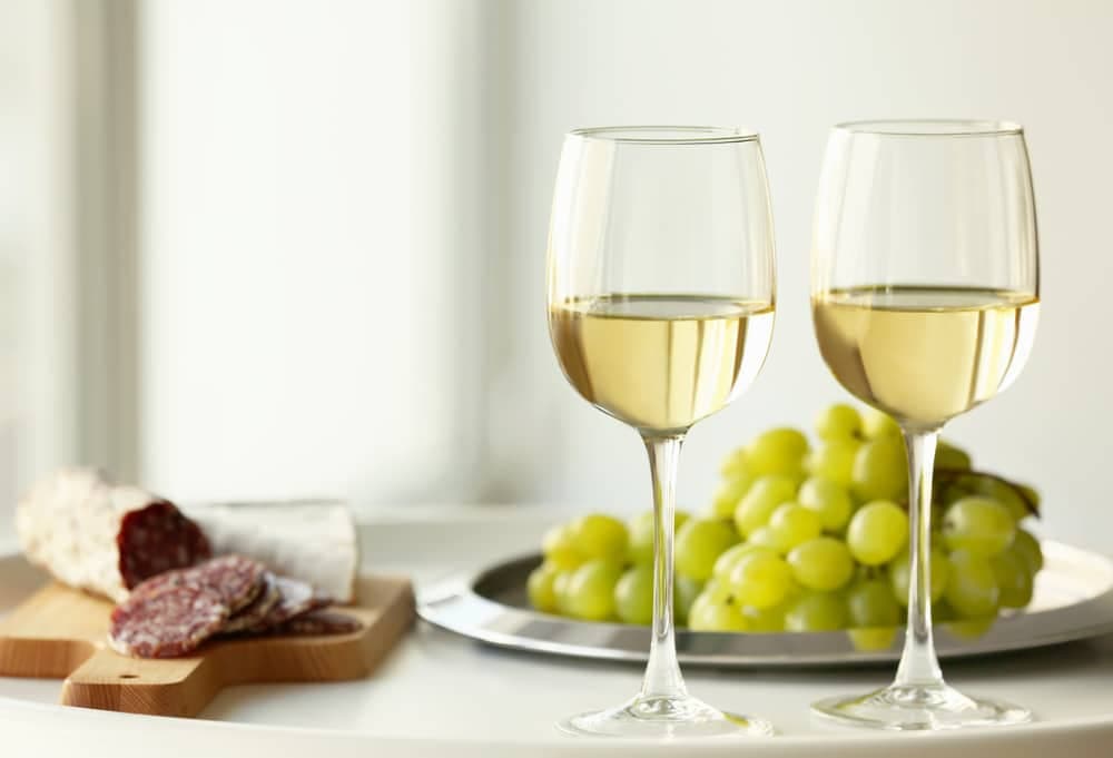 glasses-with-white-wine-and-grape-on-a-table
