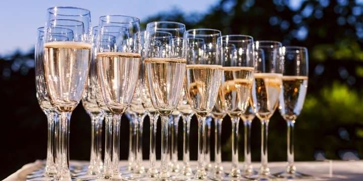the-waiter-pours-champagne-into-crystal-glasses