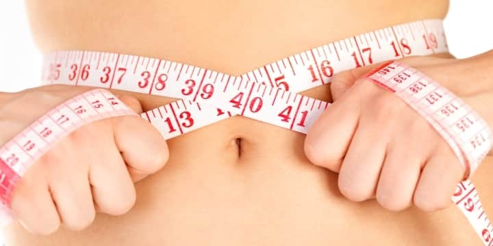 keeping-a-diet-and-fitness-rutine-measuring-tape-around-a-waist-woman