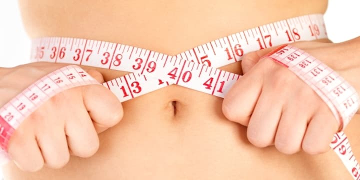 keeping-a-diet-and-fitness-rutine-measuring-tape-around-a-waist-woman