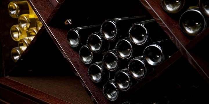 snapshot-of-the-wine-cellar-the-bottles-on-wooden-shelves