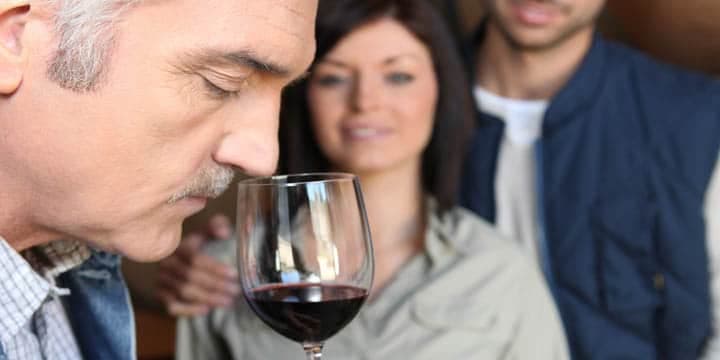 man-tasting-wine-in-cellar
